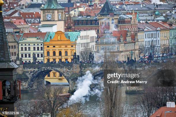 charles bridge, old town prague, clock tower, vltava river with cloud of smoke from boat - charles town stock pictures, royalty-free photos & images