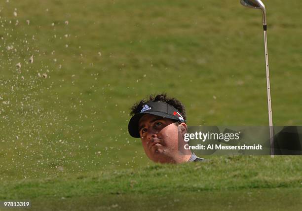 Pat Perez blasts from a deep bunker at the 18th green during a practice round at the 2006 Honda Classic March 7 at the Country Club at Mirasol in...