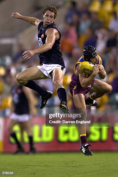 Simon Beaumont of Carlton tries to spoil the mark of Shaun Hart of Brisbane during the round three Ansett Cup match between the Brisbane Lions and...