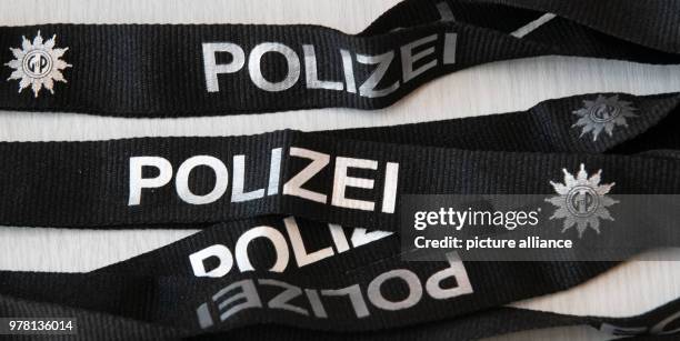 April 2018, Germany, Berlin: Lanyards reading 'Polizei' and the logo of the 'Gwerkschaft der Polizei' are on a table prior to the beginning of the...