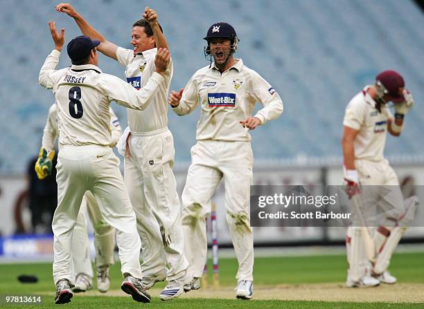 Bryce McGain of the Bushrangers celebrates with his team mates after bowling Ryan Broad of the Bulls during day two of the Sheffield Shield Final...
