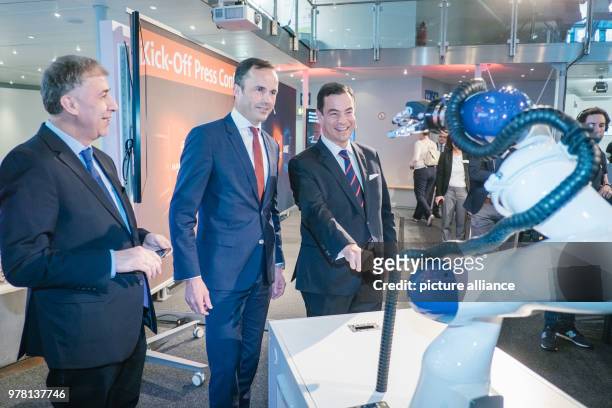 April 2018, Hannover, Germany: Paulo Carreno, Managing Director of ProMexiko , acts with a robot hand during a press conference on the Hanover Fair...
