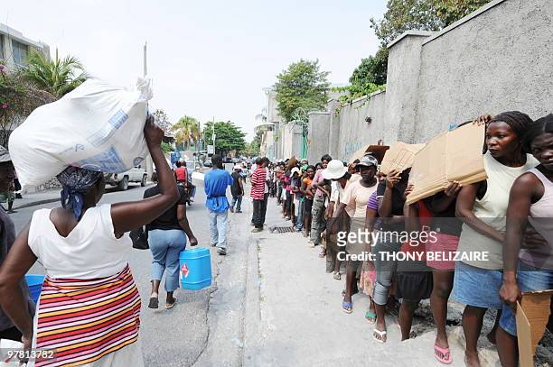 Quake victims take part to a food distribution on March 17 2010 in Petion-ville, Haiti. Haiti has unveiled the first draft of its grand...