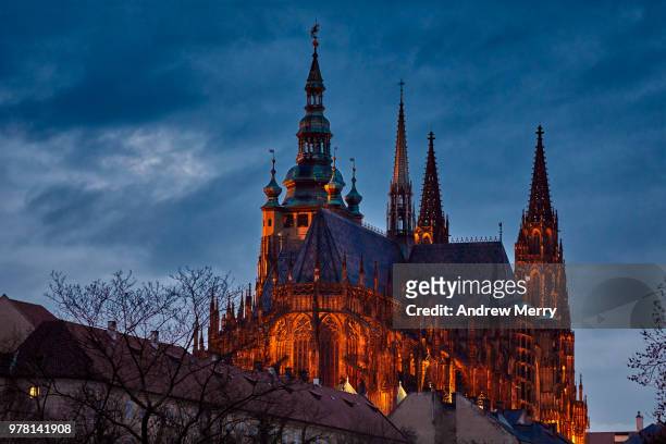 st. vitus cathedral, prague castle, hradcany, at night and illuminated by orange floodlight against dark blue sky - prague castle stock pictures, royalty-free photos & images