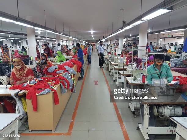 April 2018, Bangladesh, Gazipur: Red markings on the floor show the way to the exit on the factory work floor at textile manufacturer 'One Composite...