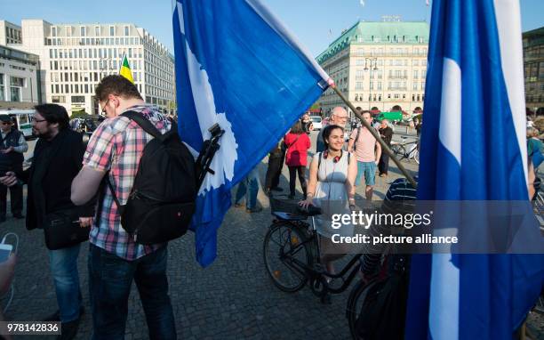 April 2018, Germany, Berlin: Protestors stand on the Pariser Platz square at the rally 'Nein zum Krieg' of The Left party. On 14 April, the USA,...