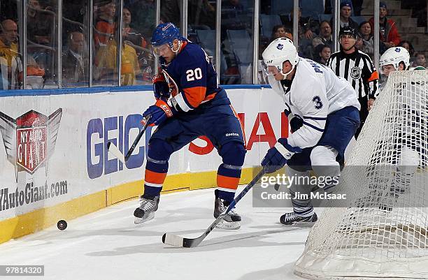 Sean Bergenheim of the New York Islanders skates against Dion Phaneuf of the Toronto Maple Leafs on March 14, 2010 at Nassau Coliseum in Uniondale,...