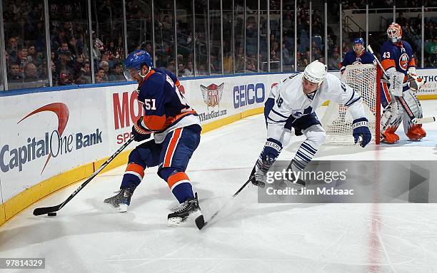 Frans Nielsen of the New York Islanders skates against Wayne Primeau of the Toronto Maple Leafs on March 14, 2010 at Nassau Coliseum in Uniondale,...