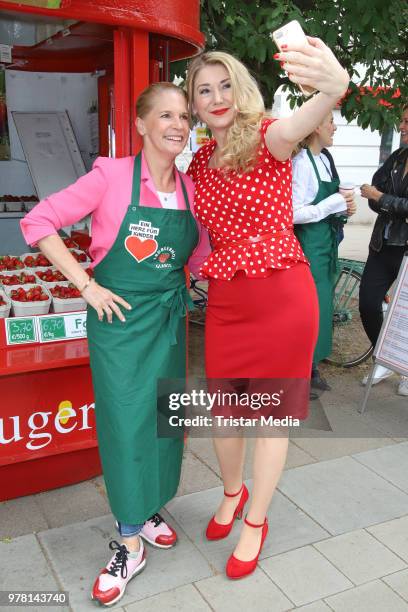 Cornelia Poletto and Sandra Quadflieg during the charity sale of strawberries and raspberries of Erdbeerhof Glantz for 'Ein Herz für Kinder' at...