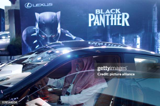 Dpatop - A man ispects a Lexus car, similar to that used in Marvel's superhero movie "Black Panther" during the opening of the AMC Entertainment...