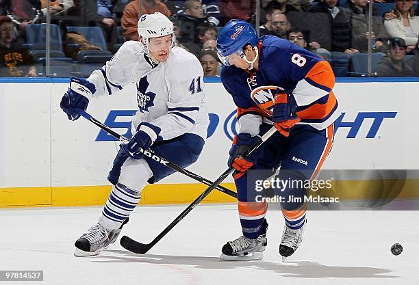 Bruno Gervais of the New York Islanders skates against Nikolai Kulemin of the Toronto Maple Leafs on March 14, 2010 at Nassau Coliseum in Uniondale,...