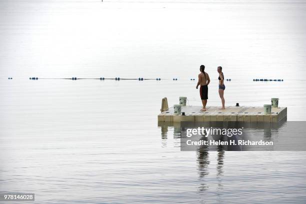 Grant Evans, left and his sister Kristen, right, check out the water to train for an upcoming triathlon they will be competeing in at Boulder...