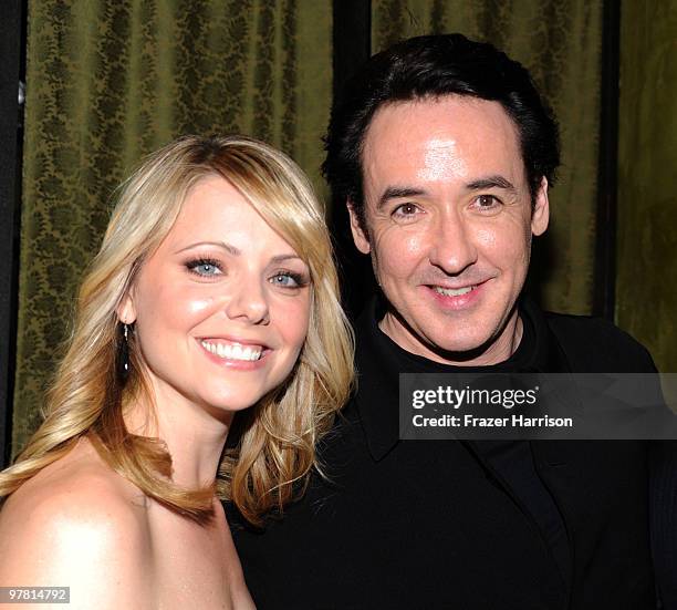 Actress Collette Wolfe and John Cusack pose at the premiere of MGM & United Artisits' "Hot Tub Time Machine" After Party at the Cabana Club on March...