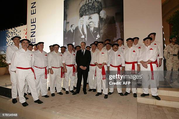 French Culture Minister Frederic Mitterrand poses with contrymen dressed in traditional clothing from southwest France during the opening ceremony of...