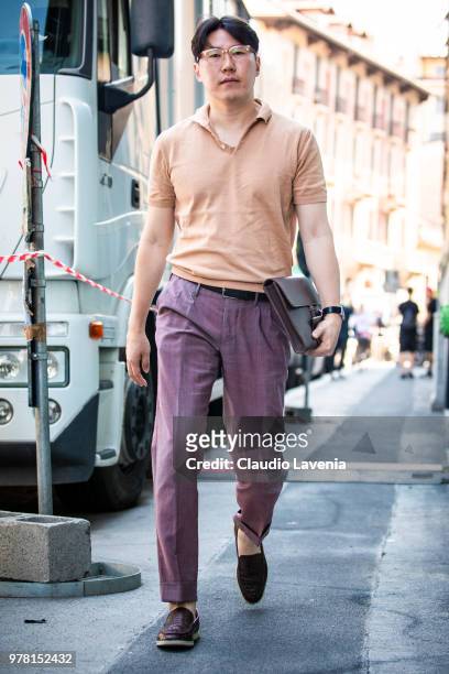 Guest, wearing brown polo shirt and purple pants, is seen in the streets of Milan before the N.21 show, during Milan Men's Fashion Week Spring/Summer...
