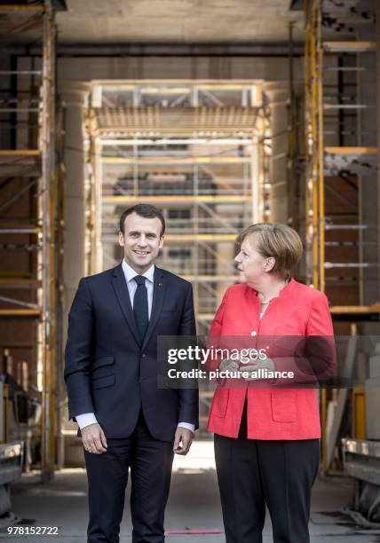 Dpatop - German Chancellor Angela Merkel receives French President Emmanuel Macron at the Humboldt Forum in the Berlin Palace, in Berlin, Germany, 19...