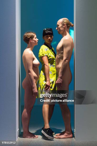 Dpatop - 19 April 2018, Bonn, Germany: A woman enters the reenactment of the performance "Imponderabilia" by walking in between a naked man and a...