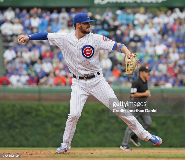 Kris Bryant of the Chicago Cubs throws to first base against the Pittsburgh Pirates at Wrigley Field on June 8, 2018 in Chicago, Illinois. The Cubs...
