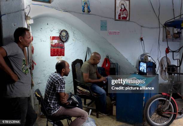 Three Cubans watch the handing over of the presidency on the television in Havana, Cuba, 19 April 2018. The Cuban parliament has elected Raul...