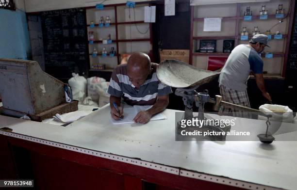 Two men waiting for customers at a small shop in Havana, Cuba, 19 April 2018. The Cuban parliament has elected Raul Castro's deputy Miguel Diaz Canel...
