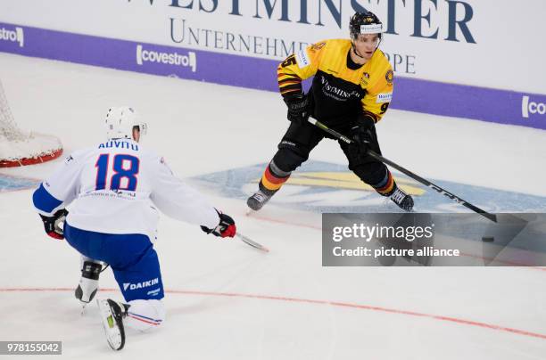 April 2018, Wolfsburg, Germany: Ice hockey, Germany vs France, Eis Arena: Germany's Frederik Tiffels and France's Yohann Auvitu vie for the puck....