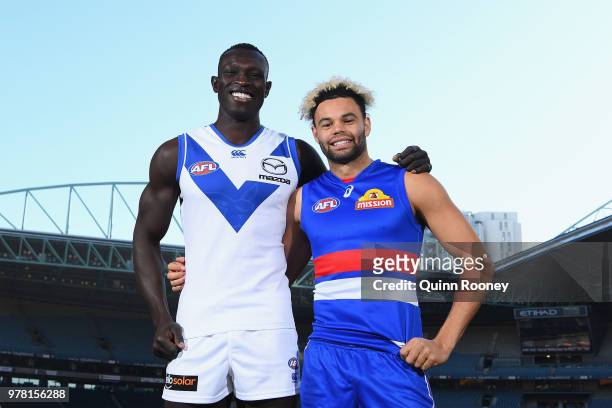 Majak Daw of the Kangaroos and Jason Johannisen of the Bulldogs pose during an AFL press conference at Etihad Stadium on June 19, 2018 in Melbourne,...