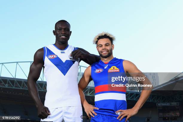 Majak Daw of the Kangaroos and Jason Johannisen of the Bulldogs pose during an AFL press conference at Etihad Stadium on June 19, 2018 in Melbourne,...