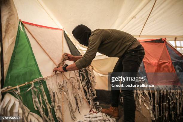 Palestinian protesters prepare kites with home made firebombs during clashes along the Israel-Gaza border, east of Gaza City, Gaza Strip, 20 April...