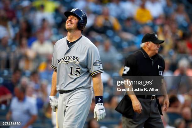 Erik Kratz of the Milwaukee Brewers walks away from home plate umpire Larry Vanover after striking out looking it the fourth inning against the...