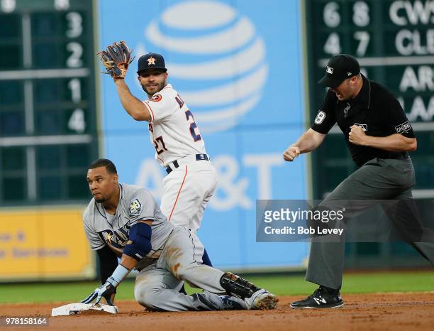 Carlos Gomez of the Tampa Bay Rays is called out trying to stretch a single by second base umpire Nic Lentz as Jose Altuve of the Houston Astros...