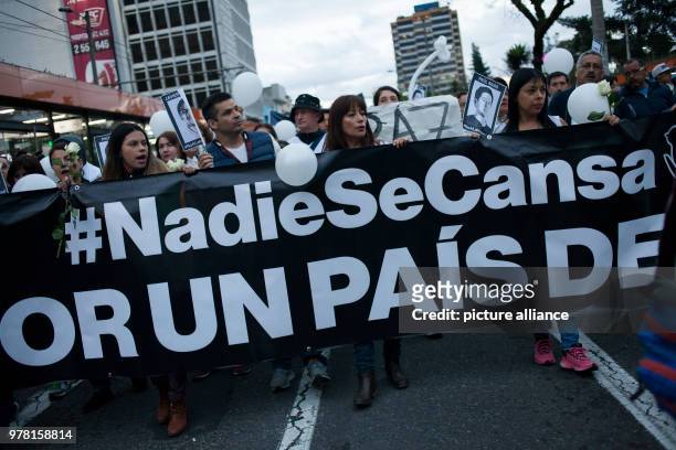 April 2018, Ecuador, Quito: Protestors hold up a banner reading 'Nadie se cansa! Por un país de Paz' . Numerous people have gathered to protest the...