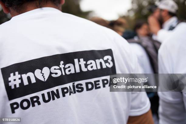 April 2018, Ecuador, Quito: A protestor wears a shirt reading '#nosfaltan3 Por un país de Paz' . Numerous people have gathered to protest the...