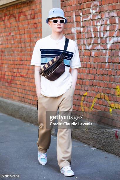 Leo Mandella, wearing white t shirt with stripes, beige pants and Fendi belt bag, is seen in the streets of Milan before the Fendi show, during Milan...