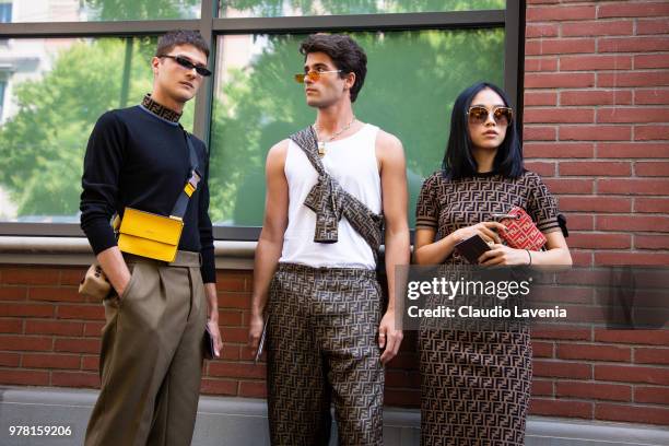 Guido Milani, in Fendi total look, Marc Forne, in Fendi total look and Niki Wujie, in Fendi total look, are seen in the streets of Milan before the...