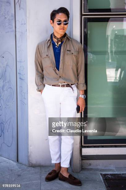 Guest, wearing beige shirt and white pants, is seen in the streets of Milan before the Giorgio Armani show, during Milan Men's Fashion Week...