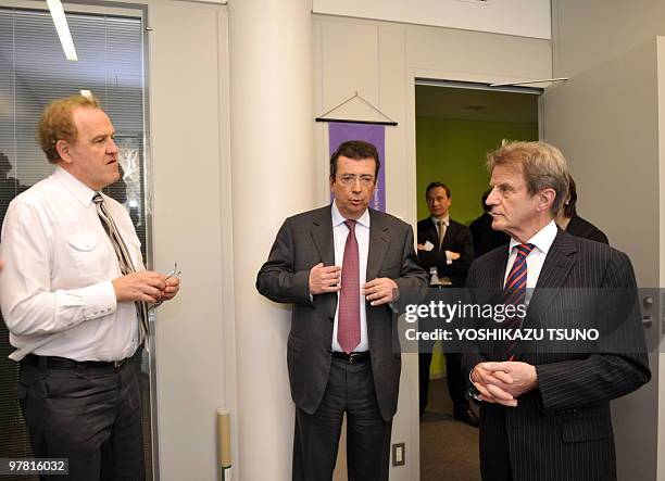 French Foreign Minister Bernard Kouchner chats with an embassy staff , while ambassador Philippe Faure looks on as he visits the newly opened French...