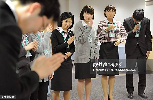 Newly recruited employees of Japanese largest supermarket chain Ito Yokado learn sign language for their customers during a four-day training program...