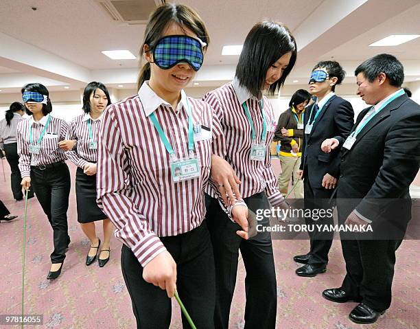 Newly recruited employees of supermarket chain Ito Yokado learn how to guide the blind, disabled and elderly customers during the four-day training...