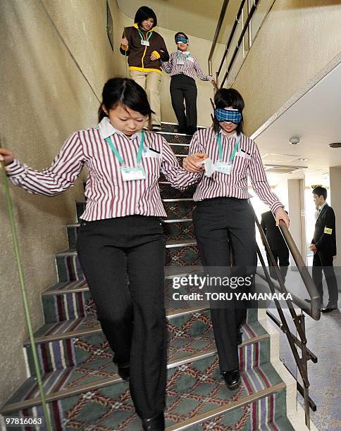 Newly recruited employees of supermarket chain Ito Yokado learn how to guide the blind, disabled and elderly customers during the four-day training...