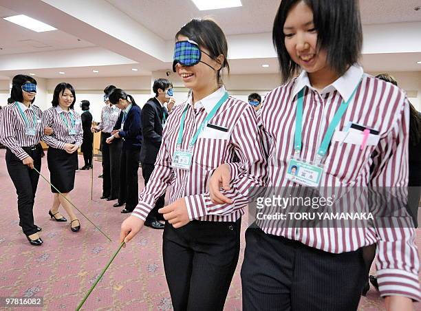 Newly recruited employees of supermarket chain Ito Yokado learn how to guide the blind, disabled and elderly customers during the four-day training...