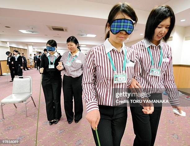 Newly recruited employees of supermarket chain Ito Yokado learn how to guide the blind, disabled and elderly customers during the four-day training...