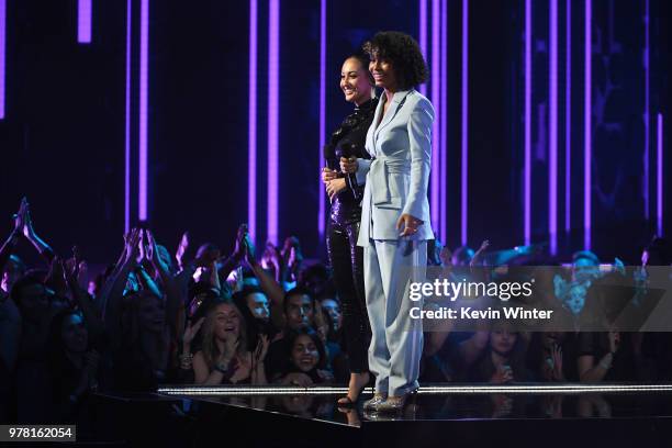 Actors Francia Raisa and Yara Shahidi speak onstage during the 2018 MTV Movie And TV Awards at Barker Hangar on June 16, 2018 in Santa Monica,...