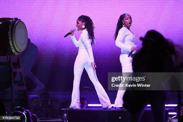 Recording artists Halle Bailey and Chloe Bailey of musical group Chloe X Halle perform onstage during the 2018 MTV Movie And TV Awards at Barker...