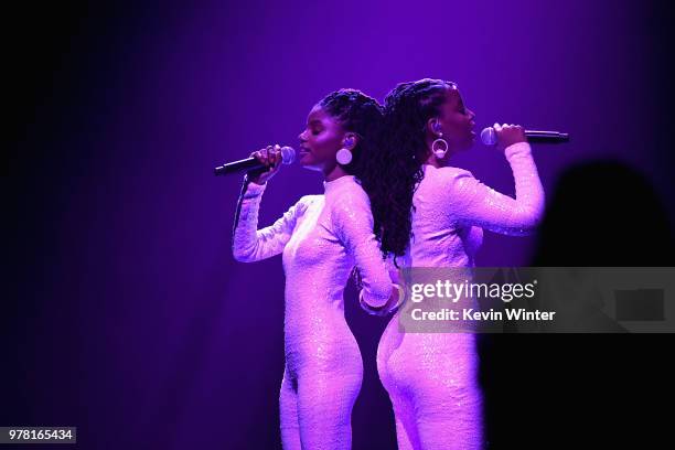 Recording artists Halle Bailey and Chloe Bailey of musical group Chloe X Halle perform onstage during the 2018 MTV Movie And TV Awards at Barker...