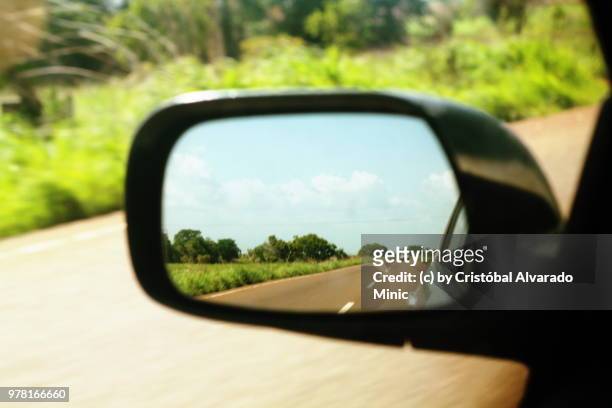 road reflected in wing mirror - rear view mirror stock pictures, royalty-free photos & images