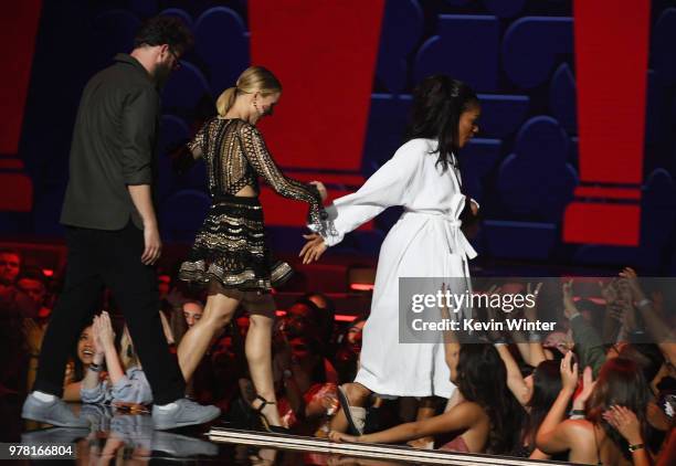 Actors Seth Rogen and Kristen Bell walk offstage with actor Tiffany Haddish, winner of the Best Comedic Performance award for 'Girls Trip,' during...