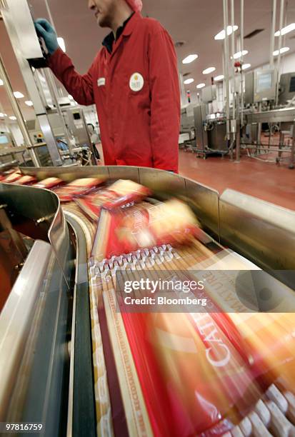 Packets of Catherdral City cheese move along the production line at the Dairy Crest factory in Nuneaton, U.K., on Wednesday, March 17, 2010. Dairy...