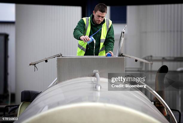 An employee takes a sample of milk from a tanker at the Dairy Crest factory in Foston, U.K., on Wednesday, March 17, 2010. Dairy Crest Group Plc said...