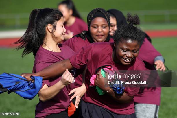 Students play tag to warm up for football during the Olympic Refugee Sport Day at The Trusts Arena on June 19, 2018 in Auckland, New Zealand. The...