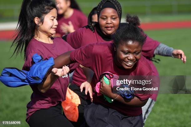 Students play tag to warm up for football during the Olympic Refugee Sport Day at The Trusts Arena on June 19, 2018 in Auckland, New Zealand. The...